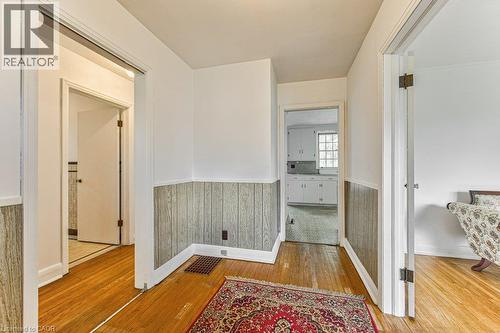 Hardwood flooring with white baseboards and wood-paneled wainscoting - 321 Highland Park, Cambridge, ON 
