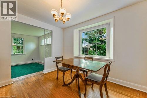 Hardwood flooring, chandelier lighting, white trim, and a prominent window - 321 Highland Park, Cambridge, ON 