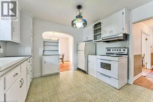 White cabinetry with open shelving and tile backsplash - 321 Highland Park, Cambridge, ON 