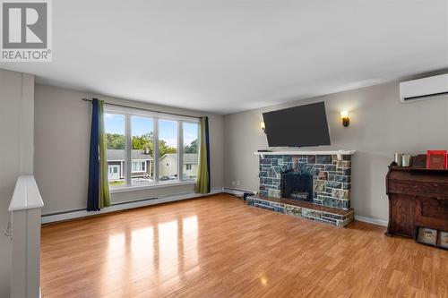 Bright living room with large front windows & fireplace - 22 Holbrook Avenue, St. John'S, NL - Indoor Photo Showing Living Room With Fireplace