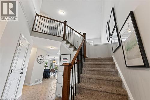 Two-story foyer with vaulted ceiling, staircase featuring wood-finish handrail and wrought iron spindles, tile flooring, and recessed lighting - 783 Frontenac Crescent, Woodstock, ON - Indoor Photo Showing Other Room
