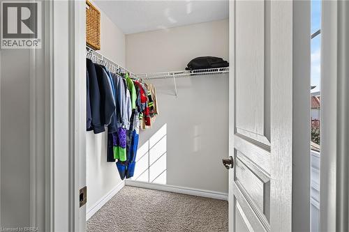 Walk-in closet featuring wire shelving, white painted walls, and neutral carpet flooring - 783 Frontenac Crescent, Woodstock, ON - Indoor With Storage
