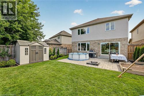 Expansive green lawn with a paver patio and a built-in fire pit - 783 Frontenac Crescent, Woodstock, ON - Outdoor With Above Ground Pool With Exterior