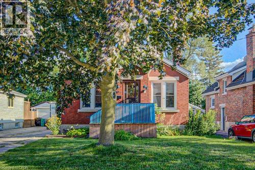 Red brick exterior with white trim windows and a blue-railed porch - 97 Francis Street, Cambridge, ON - Outdoor