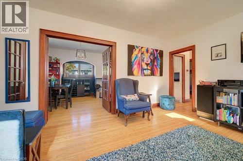 Hardwood flooring extending throughout, wide wood-trimmed doorways, and a built-in shelving unit - 97 Francis Street, Cambridge, ON - Indoor