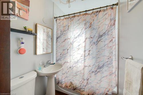 Pedestal sink with chrome faucet, framed wall mirror, and built-in shelving - 97 Francis Street, Cambridge, ON - Indoor Photo Showing Bathroom