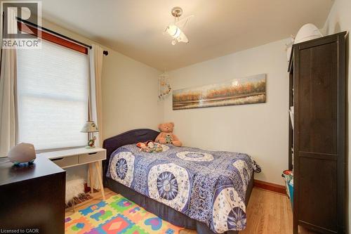 Wood-finish flooring with a white wall finish - 97 Francis Street, Cambridge, ON - Indoor Photo Showing Bedroom