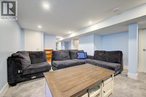 Recessed lighting illuminates a carpeted living space with light blue walls - 97 Francis Street, Cambridge, ON - Indoor Photo Showing Living Room