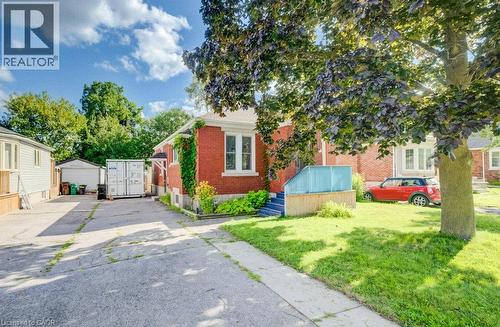 Brick exterior with white window trim and a concrete driveway - 97 Francis Street, Cambridge, ON - Outdoor