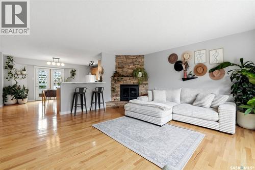 7310 Cribbs Bay, Regina, SK - Indoor Photo Showing Living Room With Fireplace