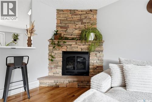7310 Cribbs Bay, Regina, SK - Indoor Photo Showing Living Room With Fireplace