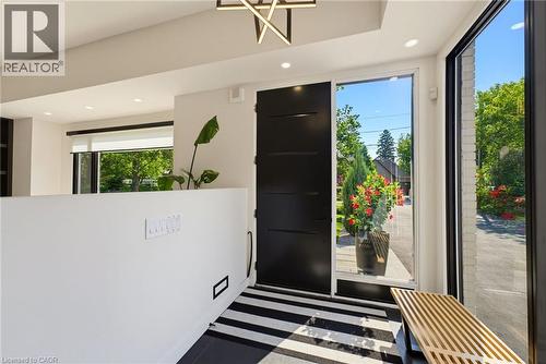 Entryway featuring a solid black door, a full-height sidelight, and a large window - 282 Robina Road, Ancaster, ON - Indoor Photo Showing Other Room