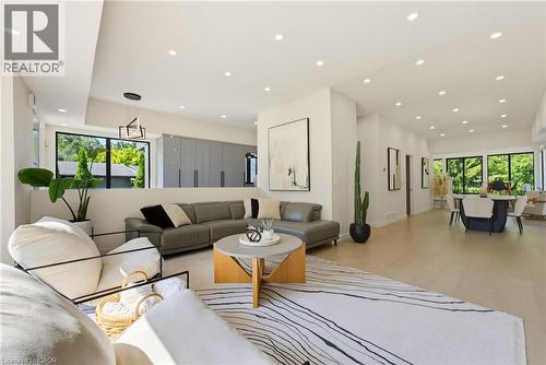 Open-concept living area with light wood-finish flooring, recessed lighting, and expansive windows - 282 Robina Road, Ancaster, ON - Indoor Photo Showing Living Room