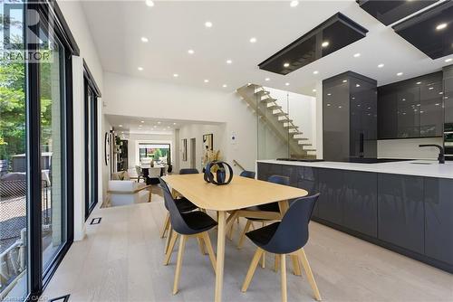 Open-concept living space featuring light wood-finish flooring, recessed lighting, and expansive floor-to-ceiling windows - 282 Robina Road, Ancaster, ON - Indoor