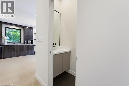 Modern vanity featuring a rectangular sink, light countertop, and a black framed mirror - 282 Robina Road, Ancaster, ON - Indoor Photo Showing Other Room