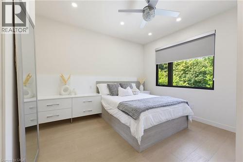 Recessed lighting illuminating light-toned walls and wood-finish flooring - 282 Robina Road, Ancaster, ON - Indoor Photo Showing Bedroom