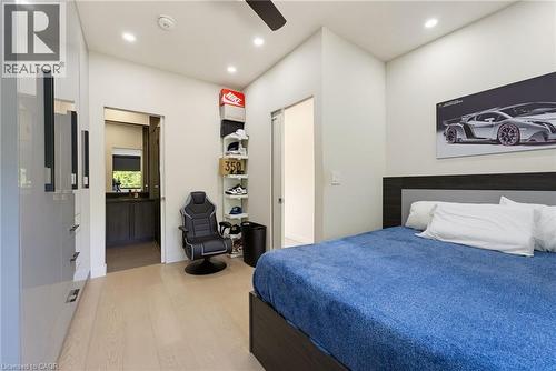 Light wood-finish flooring complements white walls and recessed lighting - 282 Robina Road, Ancaster, ON - Indoor Photo Showing Bedroom