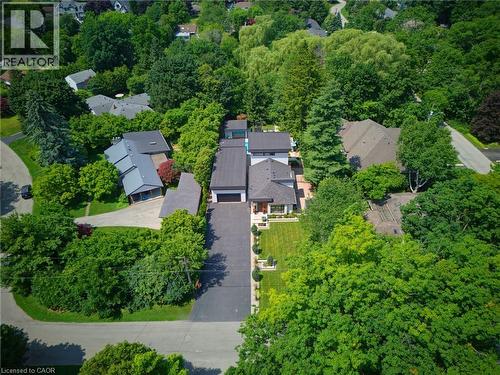 Modern residence featuring a dark-toned roof, an expansive driveway, and a well-maintained front lawn - 282 Robina Road, Ancaster, ON - Outdoor