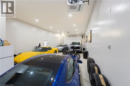 Spacious garage featuring high ceilings, recessed lighting, and multiple overhead garage doors - 282 Robina Road, Ancaster, ON - Indoor Photo Showing Other Room