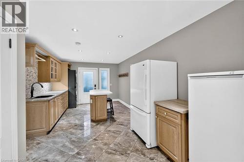 Recessed lighting, wood-finish cabinetry, tile flooring, mosaic tile backsplash, and a black gooseneck faucet - 11 Christman Court, Markham, ON - Indoor Photo Showing Kitchen