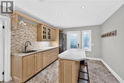 Laundry area featuring a built-in sink, wood-finish cabinetry, mosaic tile backsplash, and recessed lighting - 11 Christman Court, Markham, ON - Indoor Photo Showing Kitchen