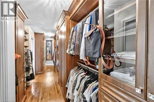 Built-in wood cabinetry with crown molding, glass-front display cabinets, closet rods, and drawer storage - 11 Christman Court, Markham, ON - Indoor With Storage