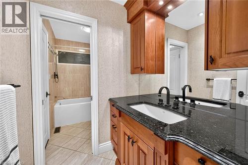 Double vanity with dark countertops, under-mount sinks, and matte black fixtures - 11 Christman Court, Markham, ON - Indoor Photo Showing Bathroom