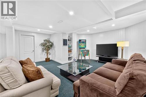 Recessed ceiling lighting, white paneling, integrated shelving unit, single panel interior door, and blue carpet flooring - 11 Christman Court, Markham, ON - Indoor Photo Showing Living Room