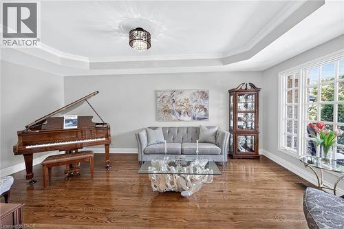 Hardwood flooring, tray ceiling, crown molding, double-pane windows, and a decorative chandelier - 11 Christman Court, Markham, ON - Indoor Photo Showing Living Room