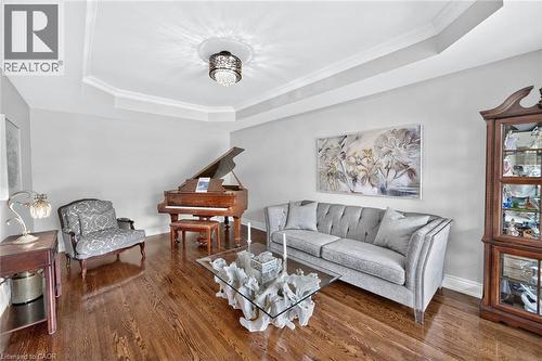 Tray ceiling with crown molding, recessed lighting, wood-finish flooring, and light wall color - 11 Christman Court, Markham, ON - Indoor Photo Showing Living Room