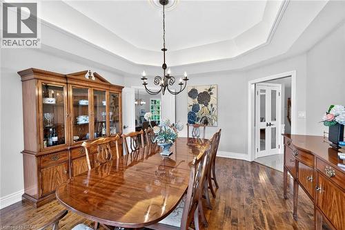 Wood-finish flooring with a tray ceiling and a chandelier - 11 Christman Court, Markham, ON - Indoor Photo Showing Dining Room