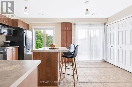 Kitchen features Tile Floors & a  Large Island - 312 Galston Private, Ottawa, ON 