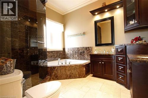 Bathroom with a shower stall, vanity, a bath, and ornamental molding - 205 Paige Place, Kitchener, ON 
