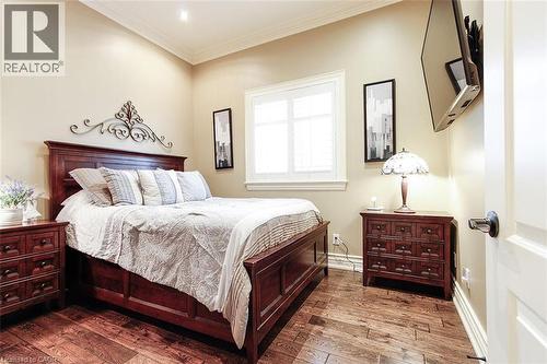 Bedroom featuring hardwood / wood-style flooring and ornamental molding - 205 Paige Place, Kitchener, ON 