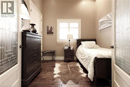 Bedroom featuring dark wood-style flooring and baseboards - 205 Paige Place, Kitchener, ON 