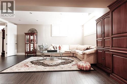 Living area featuring dark wood-style flooring and recessed lighting - 205 Paige Place, Kitchener, ON 