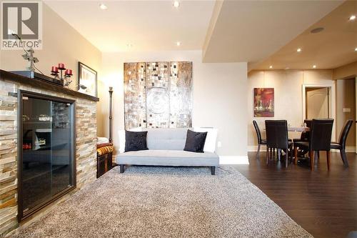 Sitting room with dark wood finished floors and recessed lighting - 205 Paige Place, Kitchener, ON 