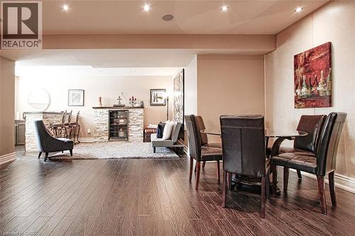 Dining room with dark wood finished floors and recessed lighting - 205 Paige Place, Kitchener, ON 