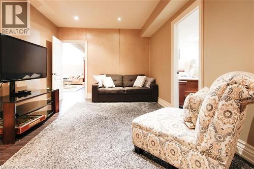Living area featuring dark wood finished floors and recessed lighting - 205 Paige Place, Kitchener, ON 