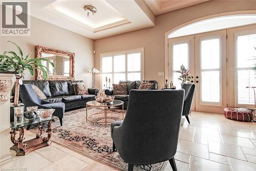 Living area featuring french doors and stone tile floors - 205 Paige Place, Kitchener, ON 