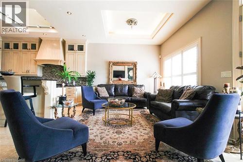 Living room featuring a raised ceiling, recessed lighting, and a skylight - 205 Paige Place, Kitchener, ON 