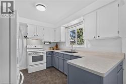 Large kitchen with plenty of storage and windows - 