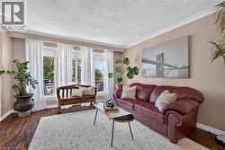 Living area with large windows facing the front yard - 