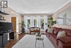 Living area with large windows facing the front yard - 