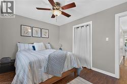 2nd bedroom features hardwood-finish flooring, ceiling fan with integrated lighting, and neutral wall paint - 