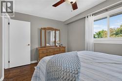 2nd bedroom features hardwood-finish flooring, ceiling fan with integrated lighting, and neutral wall paint - 