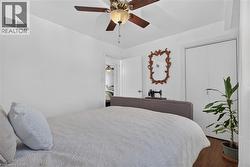 3rd bedroom features hardwood-finish flooring, ceiling fan with integrated lighting, and neutral wall paint - 
