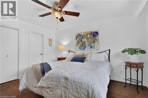 Wood-finish flooring, ceiling fan with integrated lighting, bi-fold closet doors, and solid white walls - 1083 Melton Drive, Mississauga, ON 