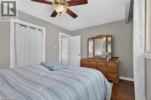 2nd bedroom features hardwood-finish flooring, ceiling fan with integrated lighting, and neutral wall paint - 1083 Melton Drive, Mississauga, ON 