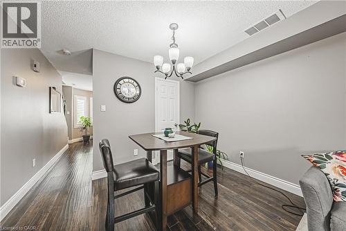 Hardwood-finish flooring throughout, featuring a five-light chandelier and white baseboards - 266 Limeridge Road E Unit# 3, Hamilton, ON 